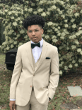 Norell McAdoo in a white suit with black tie outside