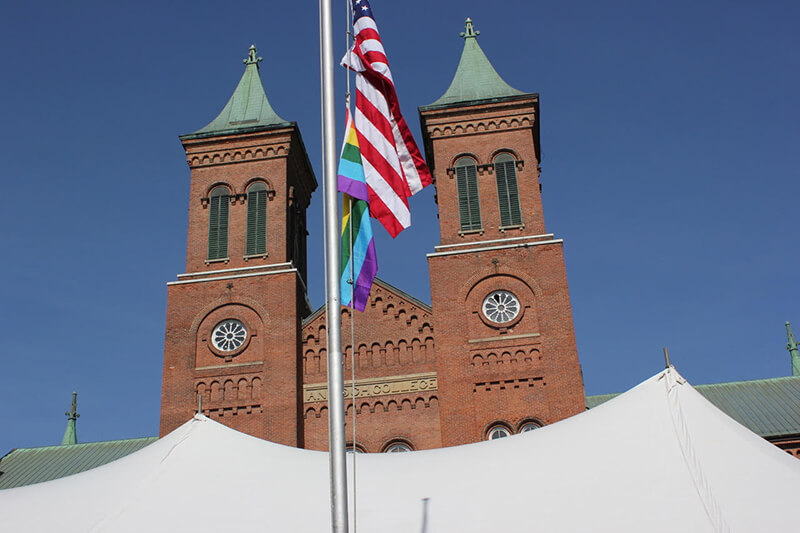 Antioch College Main Hall with two flags, US and Pride